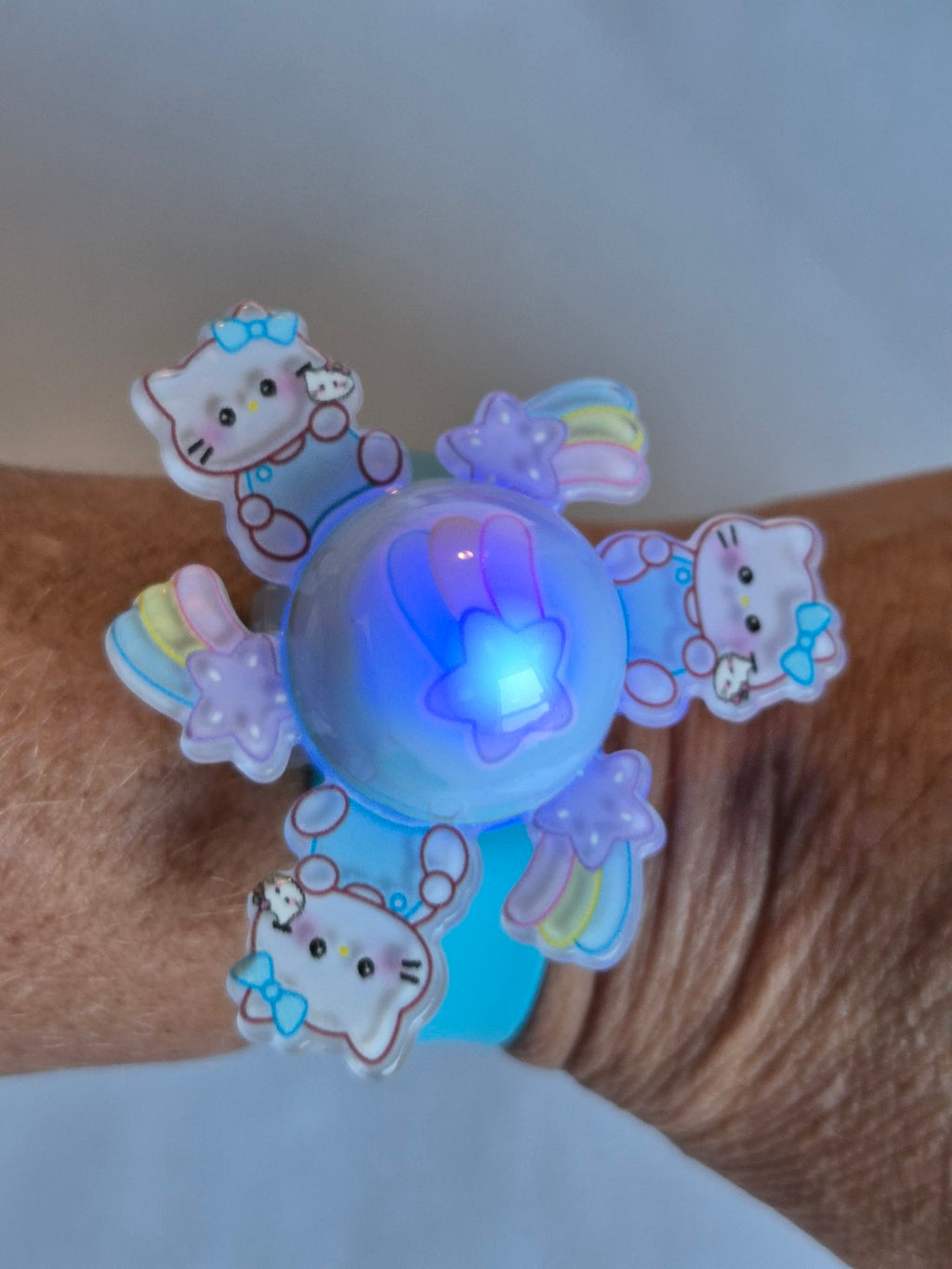 Hello Kitty Light-Up Spinner Slap Bracelet - Blue lit up on wrist