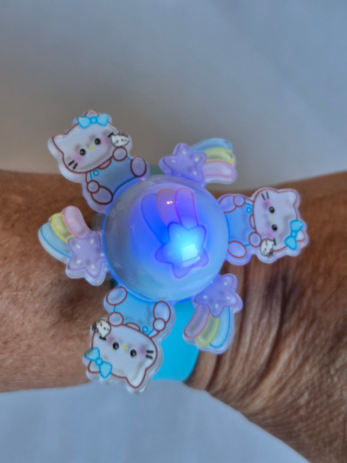 Hello Kitty Light-Up Spinner Slap Bracelet - Blue lit up on wrist