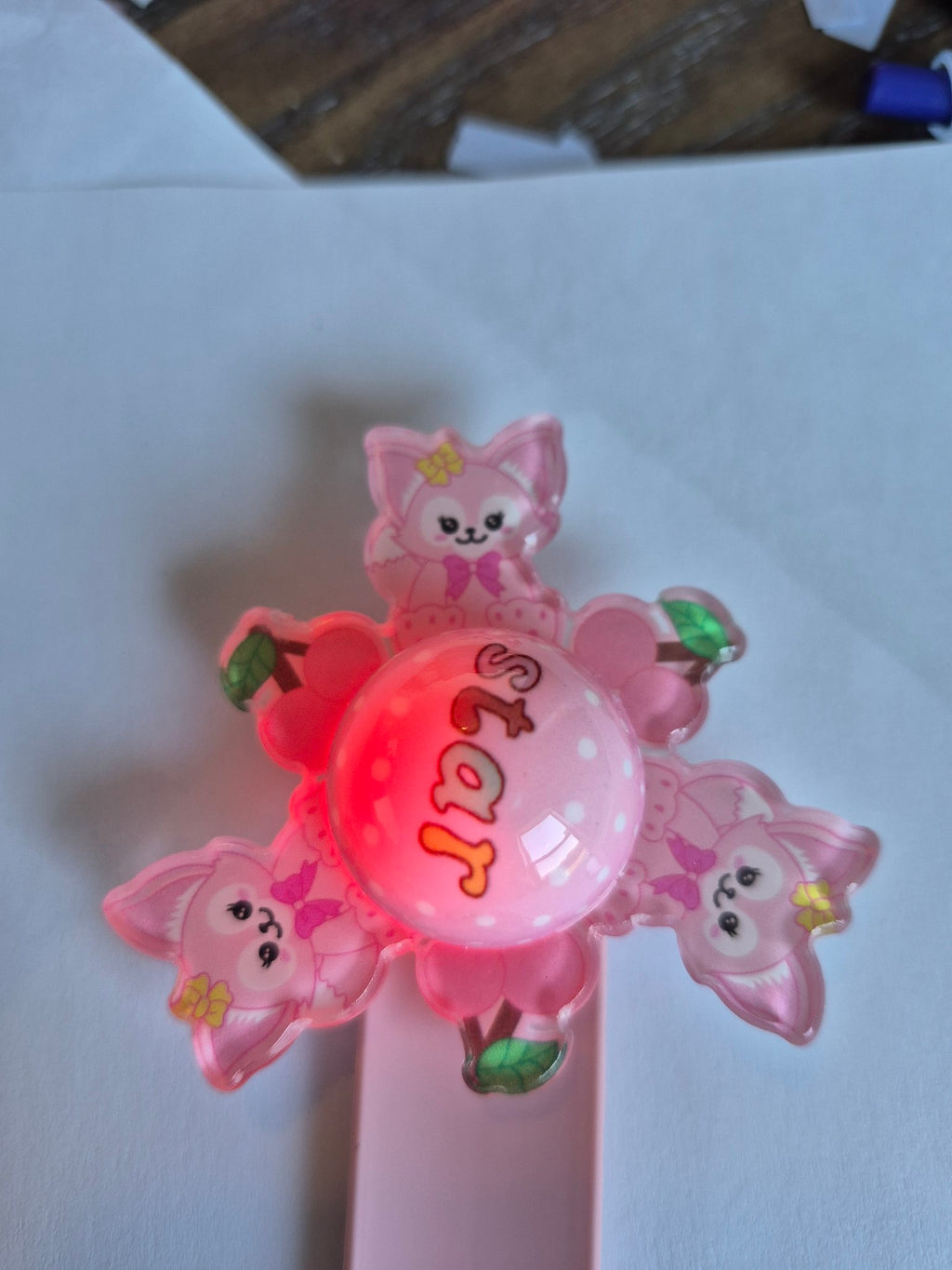 Pink Fox Light-Up Spinner Slap Bracelet - Cherry spinner top close-up