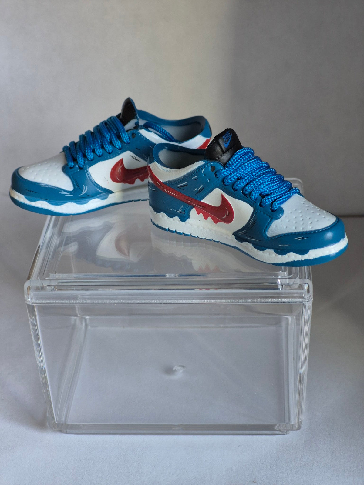 Blue and White Mini Sneakers with Red Drip Swoosh – Collectible Pair with Display Case
