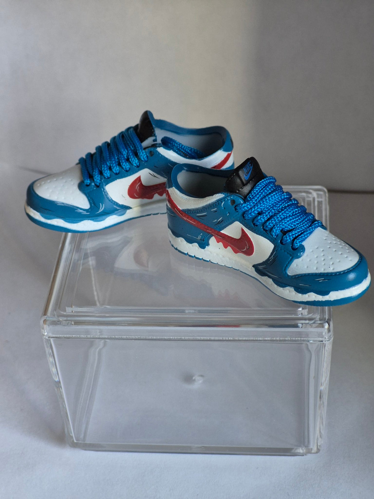 Blue and White Mini Sneakers with Red Drip Swoosh – Collectible Pair with Display Case