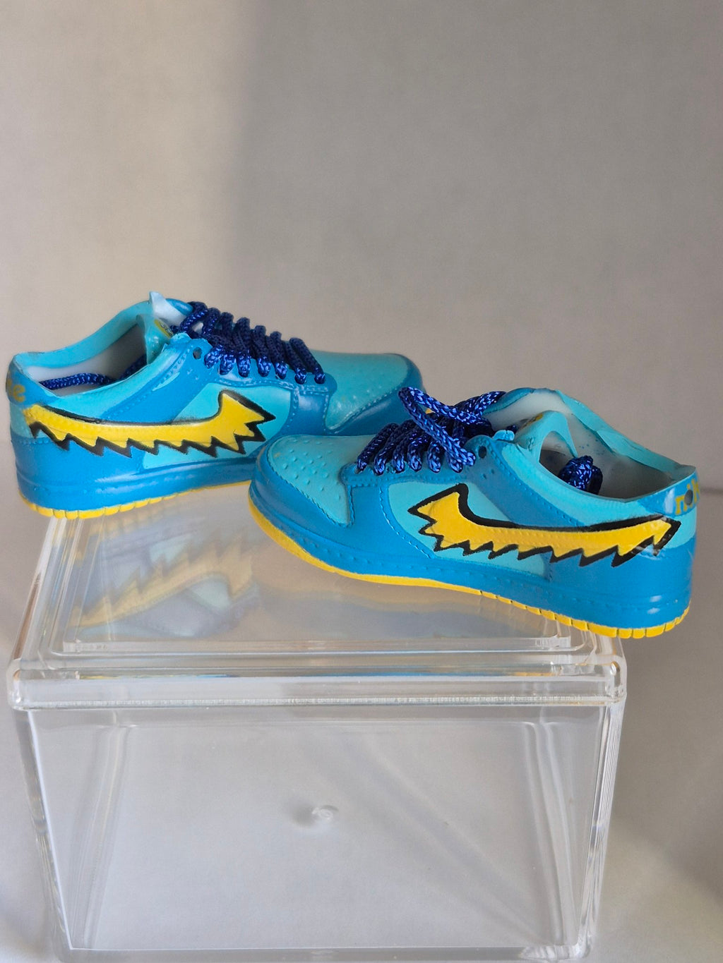 Blue Mini Sneakers with Yellow Swoosh – Collectible Pair with Display Case