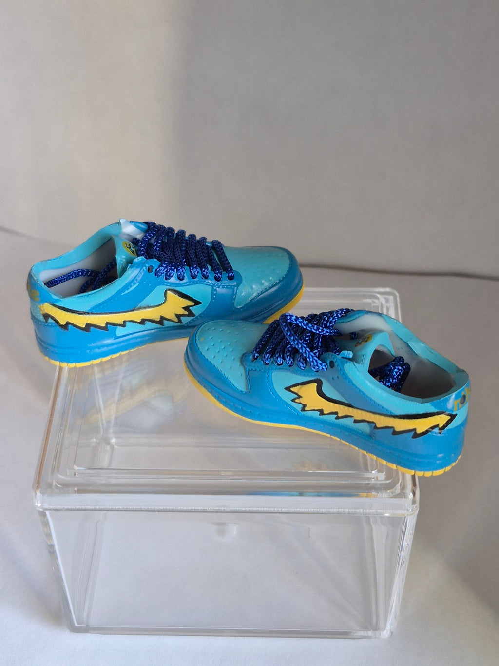 Blue Mini Sneakers with Yellow Swoosh – Collectible Pair with Display Case