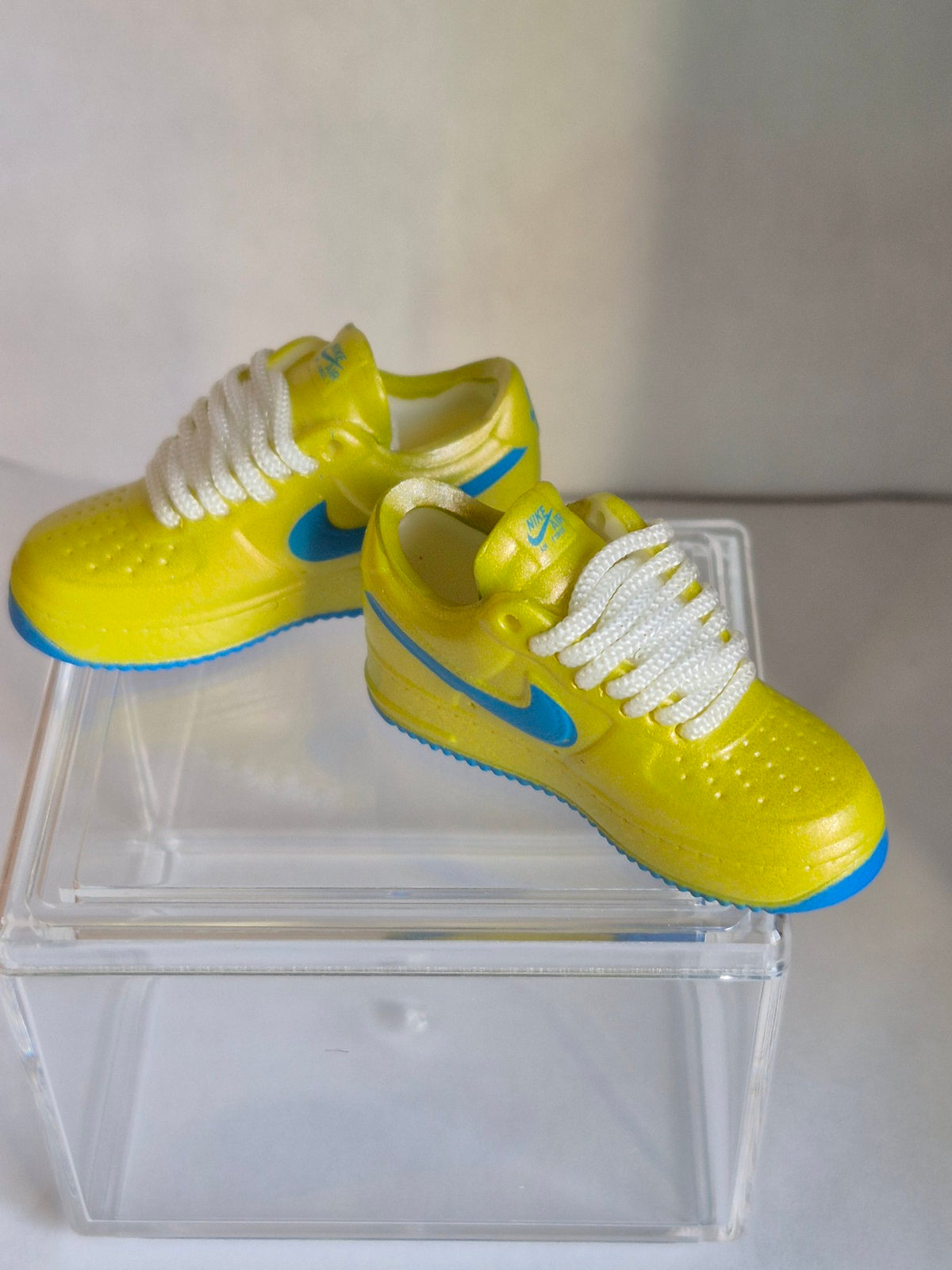 Yellow Mini Sneakers with Blue Swoosh – Collectible Pair with Display Case