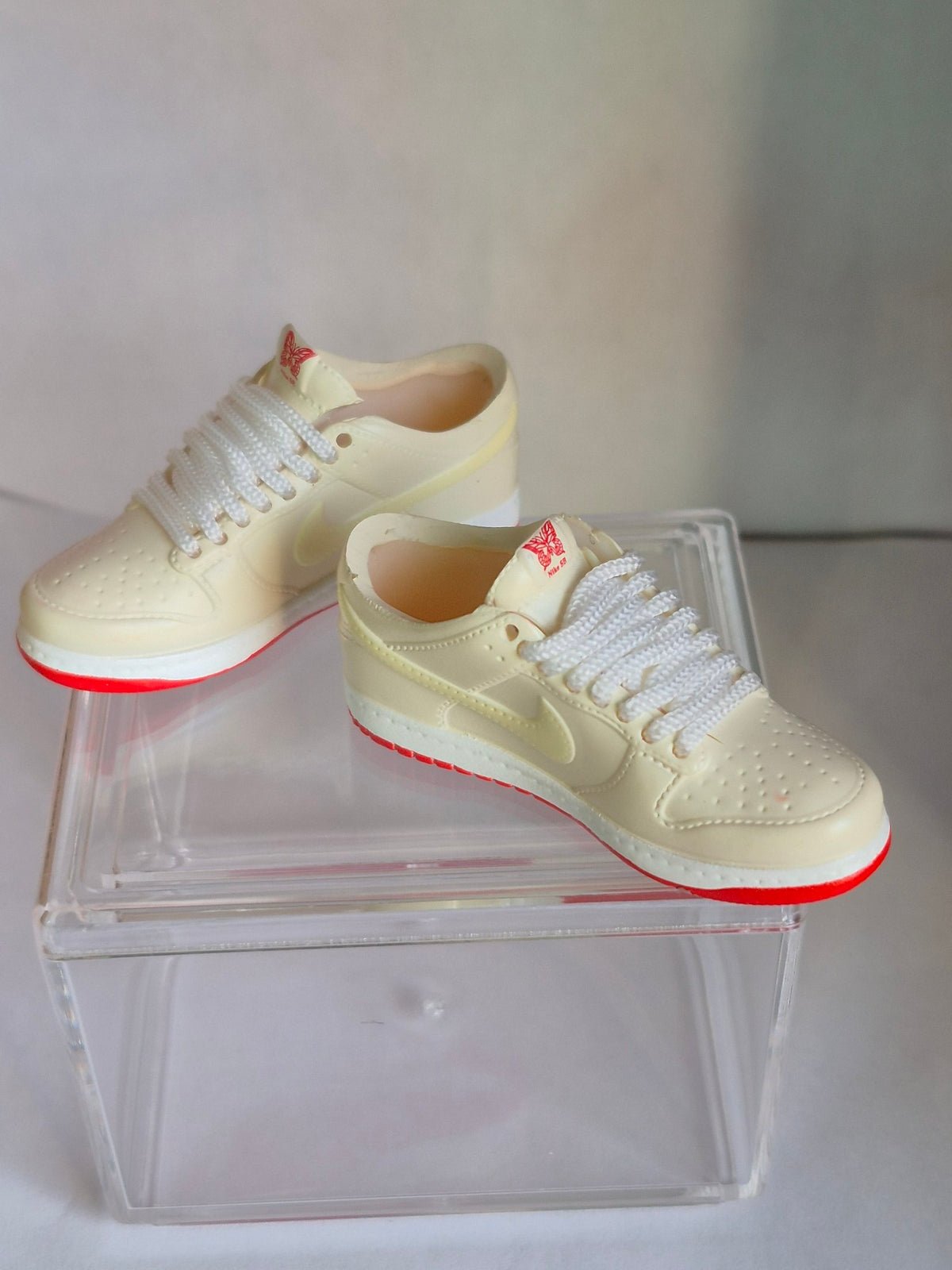 Cream Mini Sneakers with Red Sole – Collectible Pair with Display Case