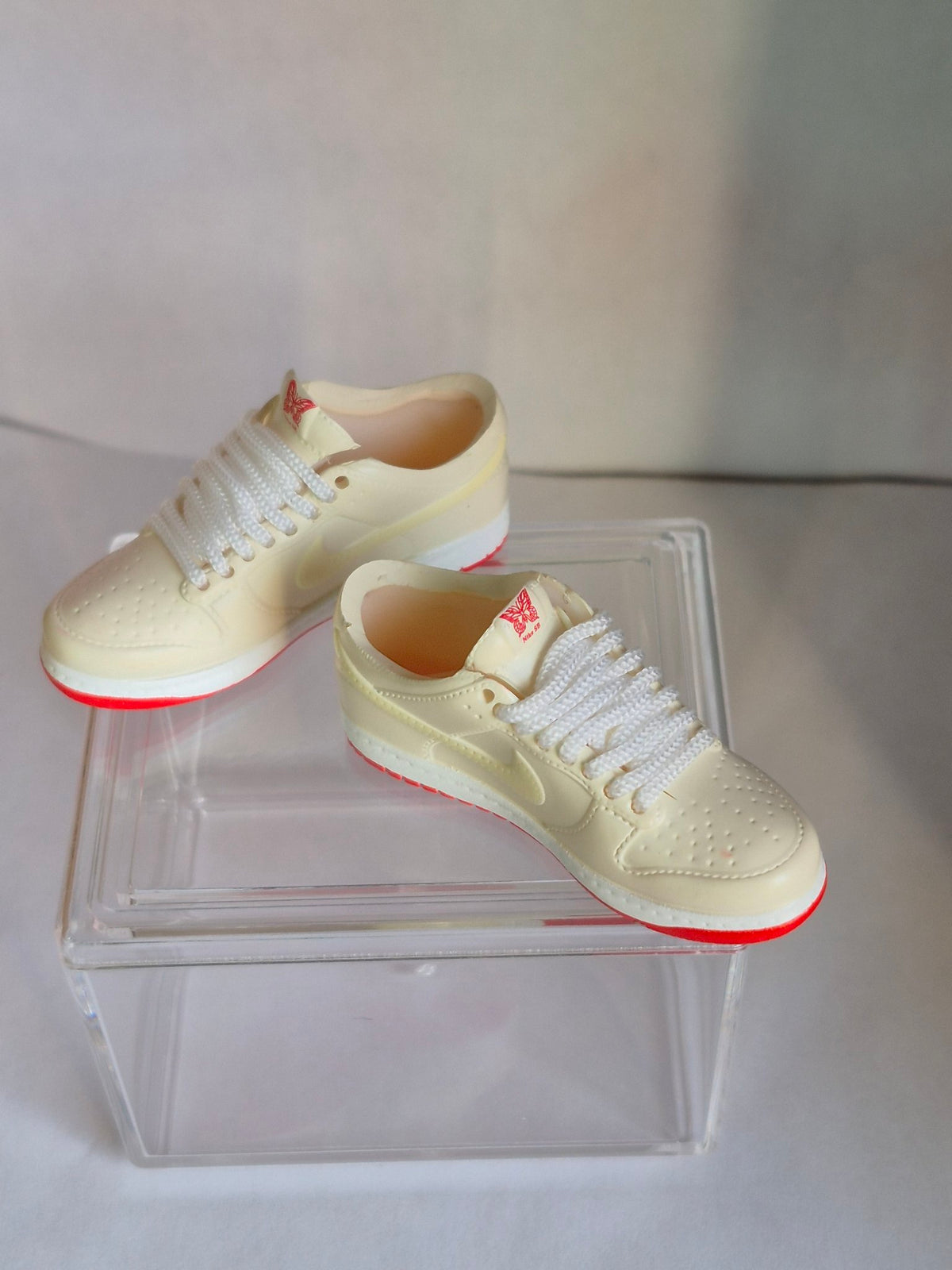 Cream Mini Sneakers with Red Sole – Collectible Pair with Display Case