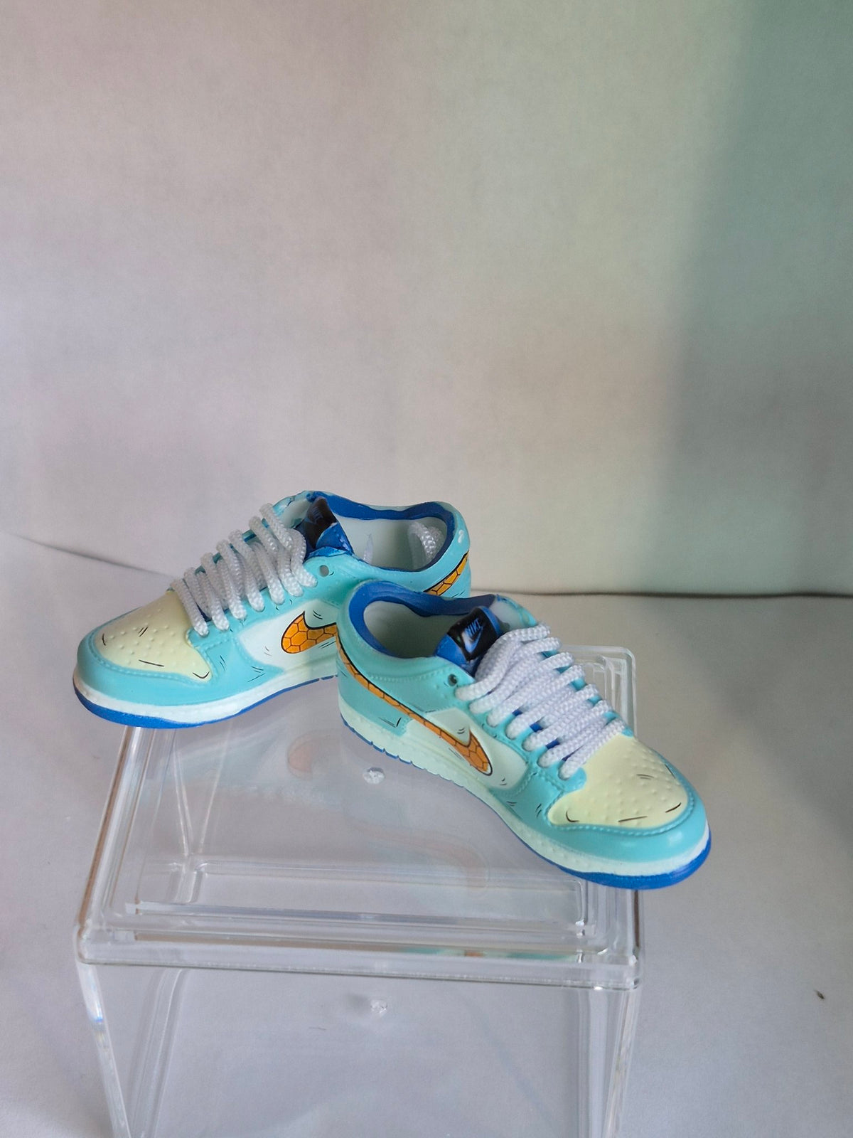 Light Blue Mini Sneakers with Honeycomb Swoosh – Collectible Pair with Display Case