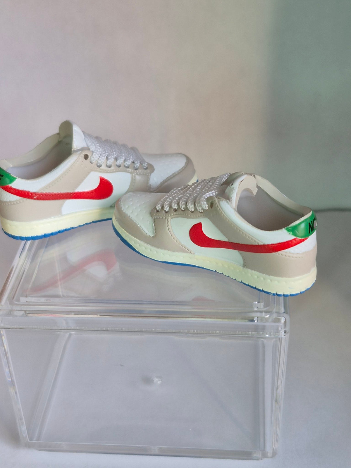 Beige and White Mini Sneakers with Red Swoosh – Collectible Pair with Display Case