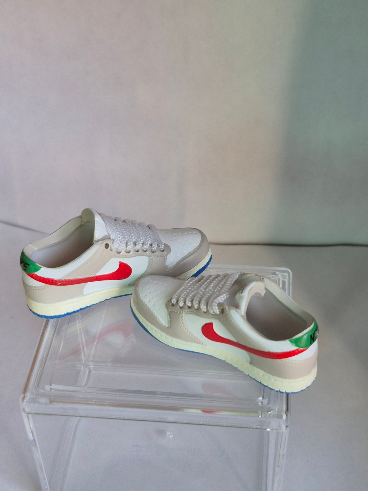 Beige and White Mini Sneakers with Red Swoosh – Collectible Pair with Display Case