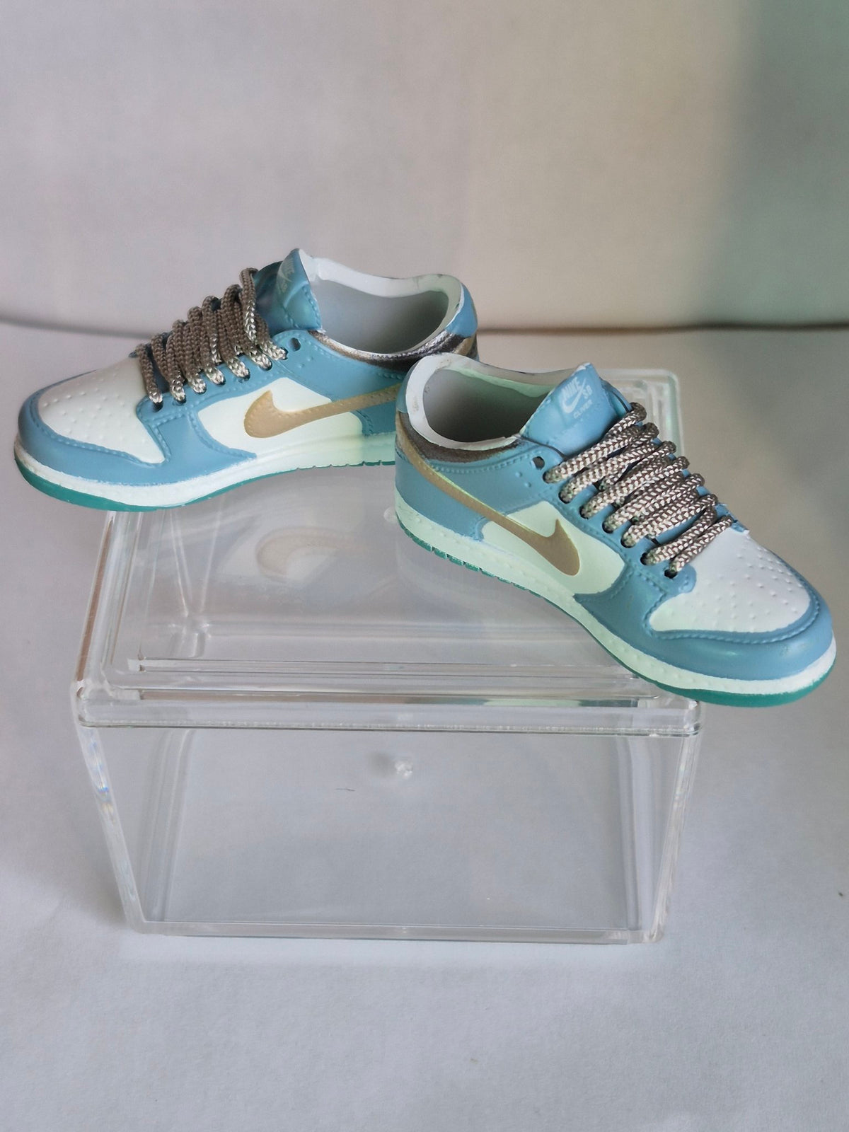 Light Blue and White Mini Sneakers with Gold Swoosh – Collectible Pair with Display Case