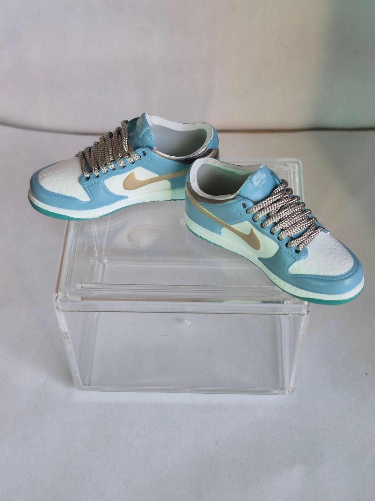 Light Blue and White Mini Sneakers with Gold Swoosh – Collectible Pair with Display Case
