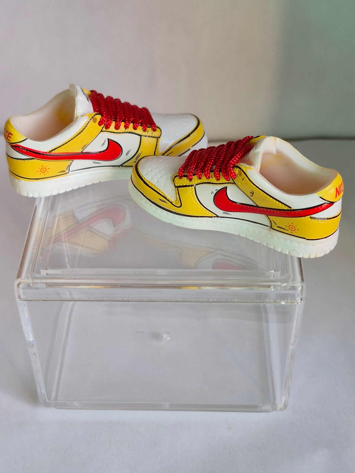 Yellow and White Cartoon Mini Sneakers with Red Swoosh – Collectible Pair with Display Case