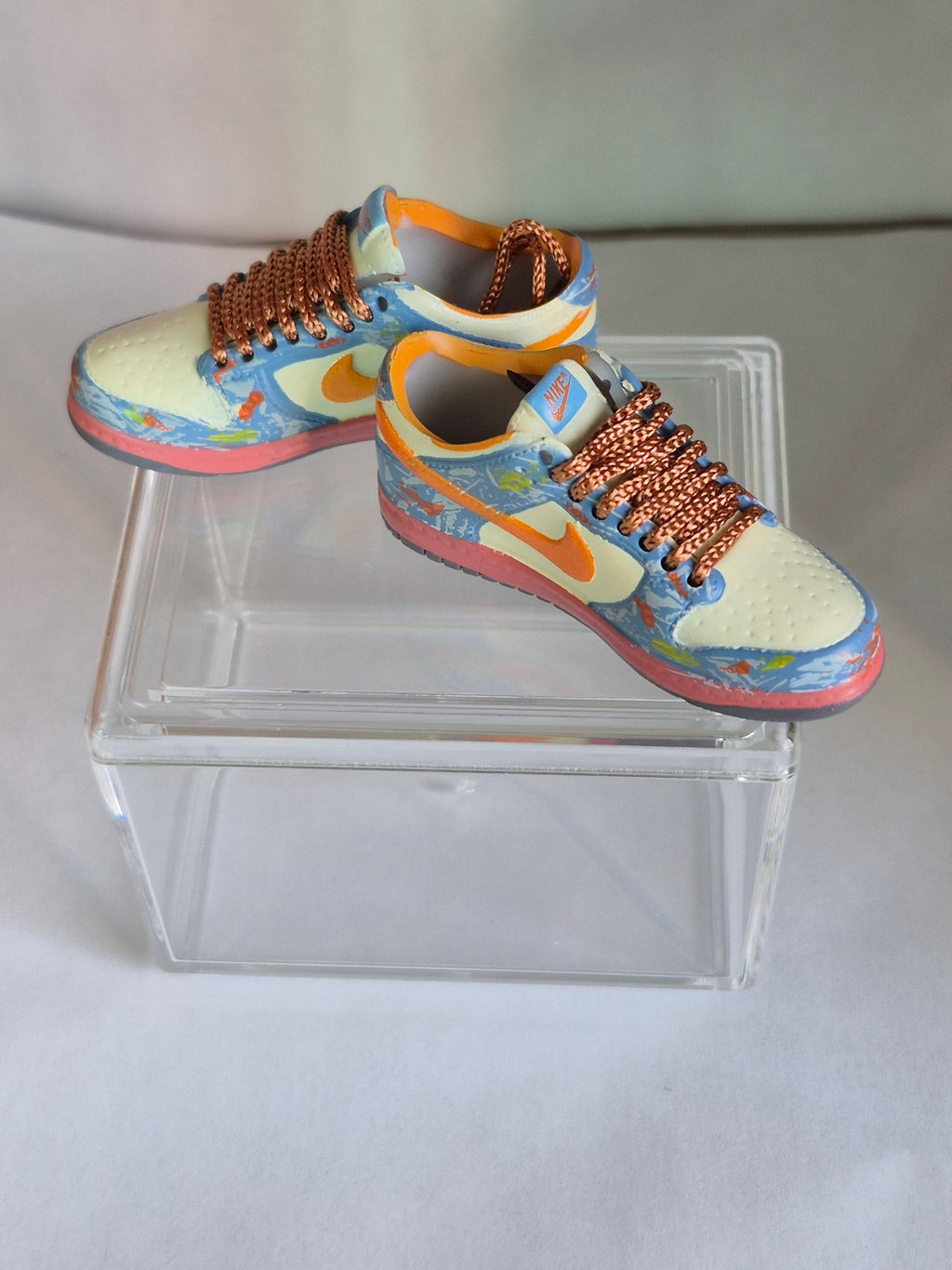 Blue Splatter Mini Sneakers with Orange Swoosh – Collectible Pair with Display Case