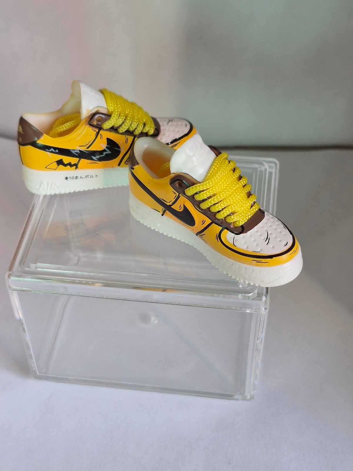 Yellow Cartoon Bolt Mini Sneakers – Collectible Pair with Display Case