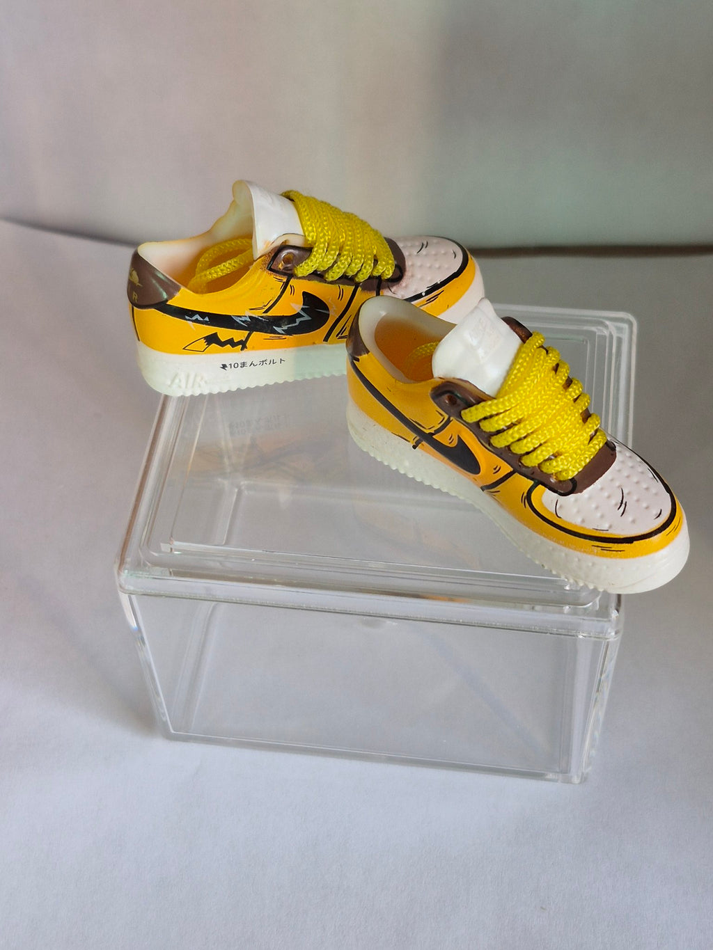 Yellow Cartoon Bolt Mini Sneakers – Collectible Pair with Display Case