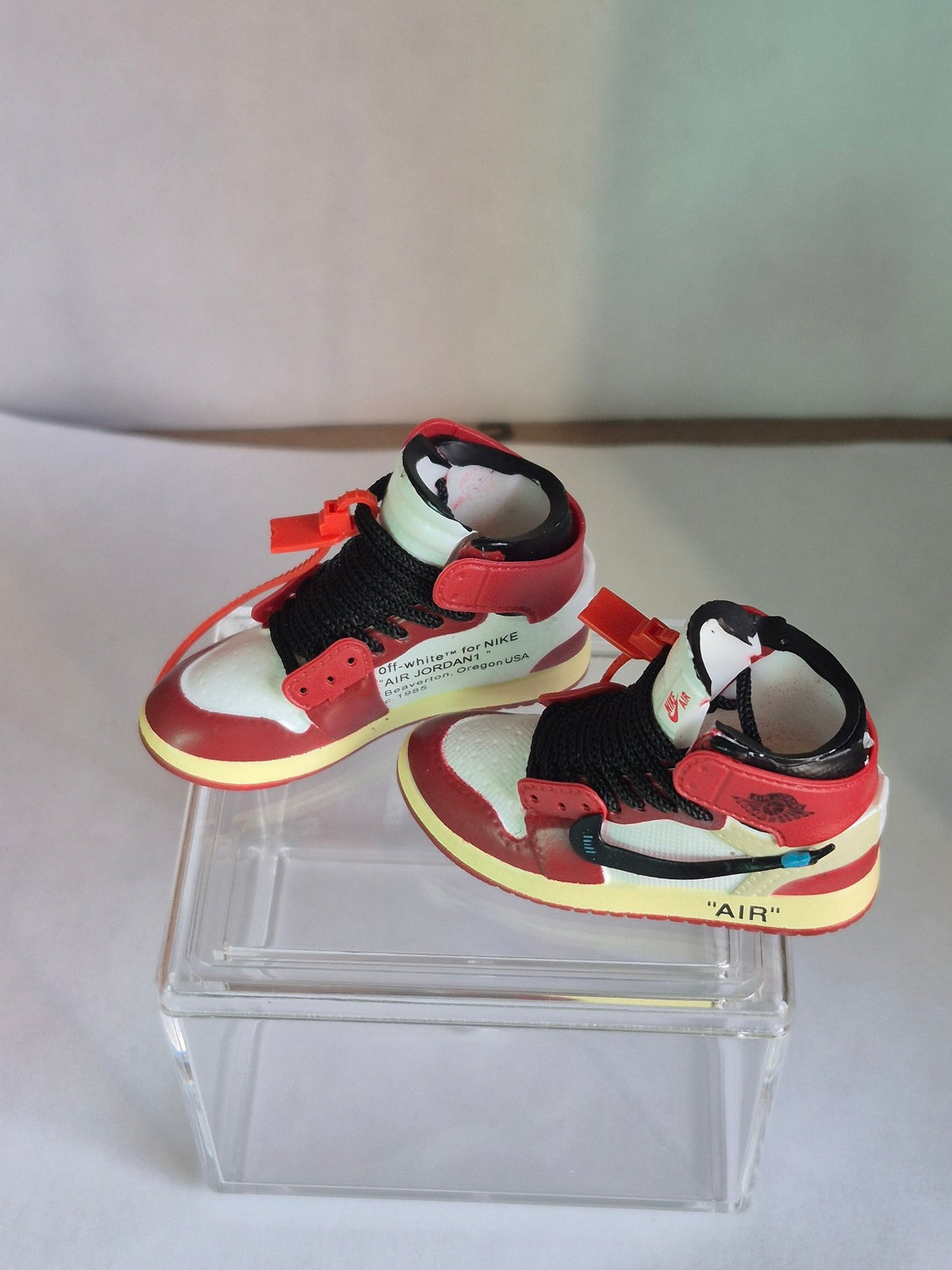 Red and white designer-style high-top mini sneakers, second view